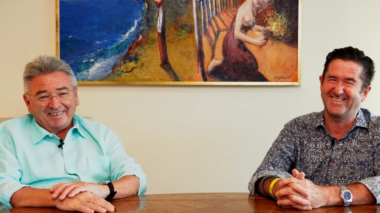 Dick and Steve laughing together at a table.